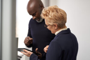 Photo of a male CHRO and a female CIO collaborating in an office​.